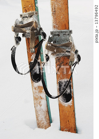 old wooden skis in the snow 13796492