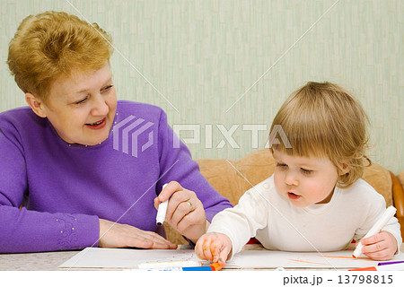 Small cute painting girl with grandma at home 13798815