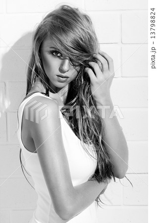 Young girl in white swimsuit on white wall (monochrome version) 13798824