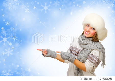 Young girl with fur hat showing pointing gesture Young girl with fur hat showing pointing gesture 13798826