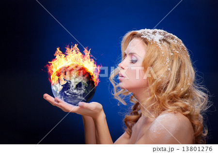Frozen girl holding burning earth globe 13801276