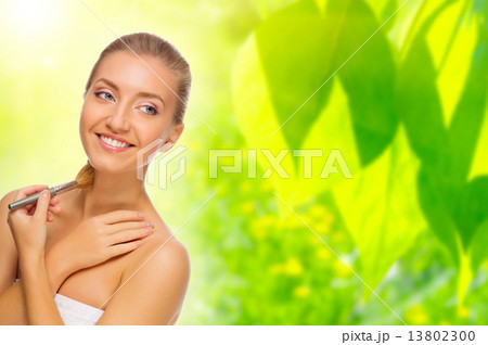 Woman with makeup brush on floral background 13802300