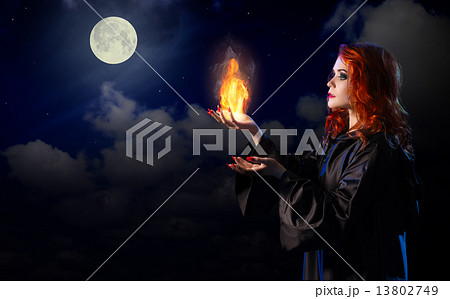 Witch with flame on night sky background Witch with flame on night sky background 13802749