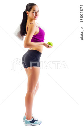 Young sporty woman with towel and apple 13802875