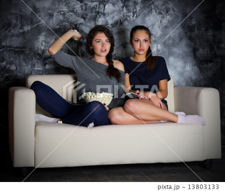 Two young girls looks TV 13803133