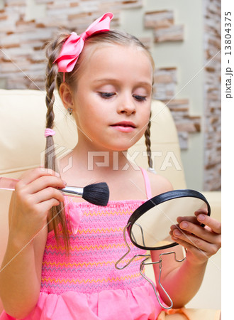 Little girl puts makeup 13804375