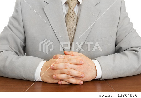 Businessman wearing suit with hands clasped isolated 13804956