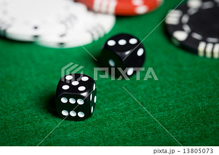 close up of black dices on green casino table 13805073