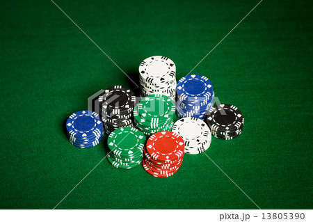 close up of casino chips on green table surface close up of casino chips on green table surface 13805390