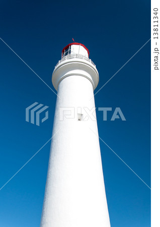White Lighthouse Against Blue Sky 13811340