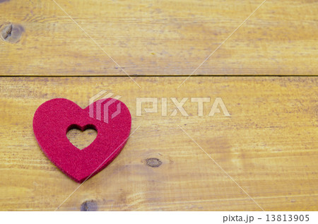 Red heart on a wooden table 13813905