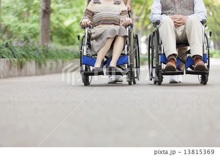 車いすを押す介護士と車いすに座る老人 13815369
