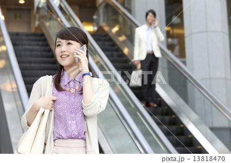 スマートフォンで電話しているビジネスウーマン スマートフォンで電話しているビジネスウーマン 13818470