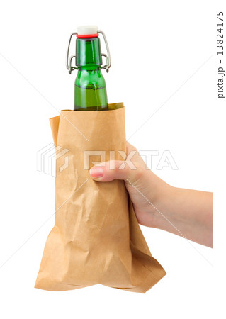 Hand and beer bottle in paper packet 13824175