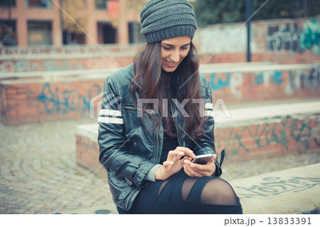 young beautiful brunette woman using smartphone young beautiful brunette woman using smartphone 13833391