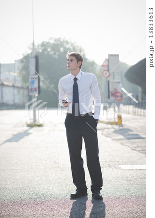young handsome elegant blonde model man using smart phone 13833613