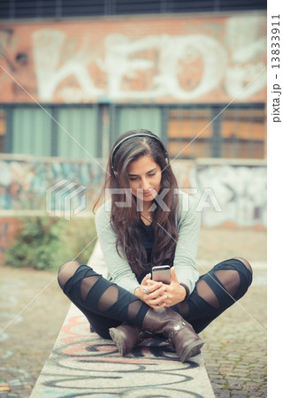 young beautiful brunette woman listening music with headphones young beautiful brunette woman listening music with headphones 13833911