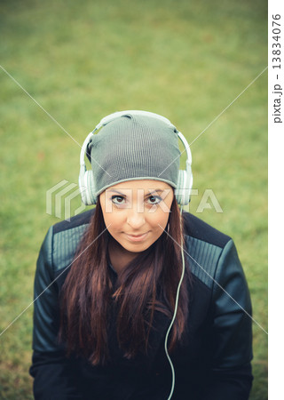 young beautiful brunette straight hair woman in the park 13834076