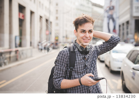 young handsome alternative dark model man in town listening to m 13834230