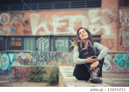 young beautiful brunette woman listening music with headphones 13834251