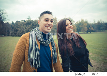 young couple in the park during autumn season outdoor 13834332
