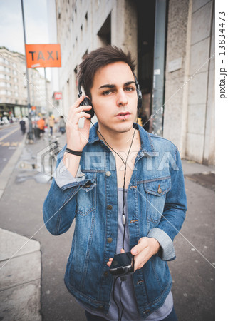 young handsome alternative dark model man in town listening to m 13834473