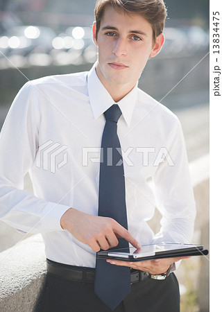 young handsome elegant blonde model man using tablet 13834475