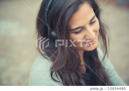 young beautiful brunette woman listening music with headphones 13834480