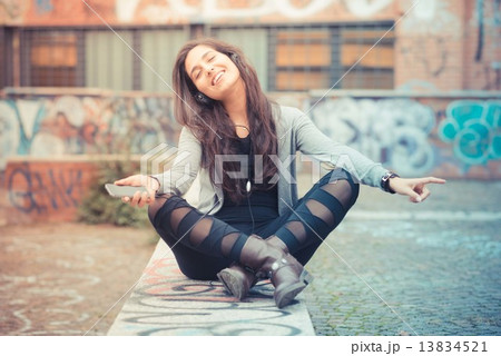 young beautiful brunette woman listening music with headphones 13834521