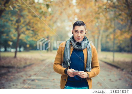 young handsome caucasian man in autumn park young handsome caucasian man in autumn park 13834837