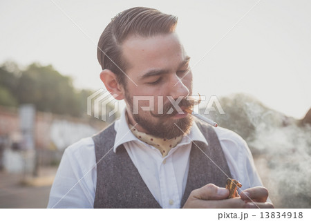 handsome big moustache hipster man smoking cigarette handsome big moustache hipster man smoking cigarette 13834918