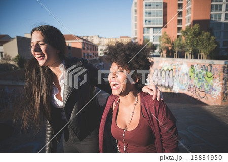 two multiethnic beautiful young woman black and white having fun 13834950