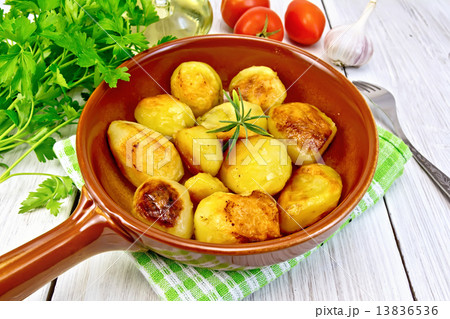 Potatoes fried in ceramic pan on light board 13836536