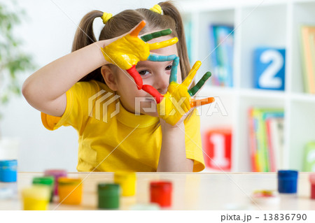 cute kid have fun painting her hands 13836790