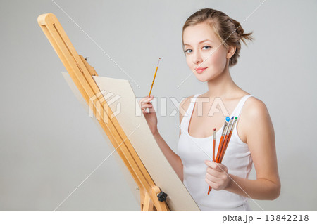 Artist with paintbrushes and canvas over white Artist with paintbrushes and canvas over white 13842218