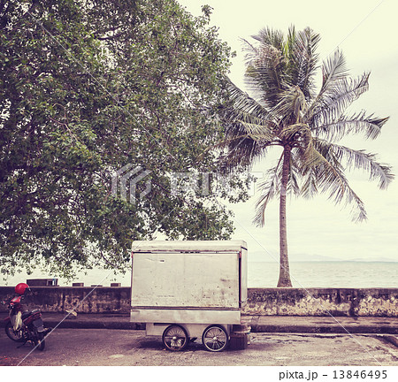 Retro filtered picture of food cart on seaside street. 13846495