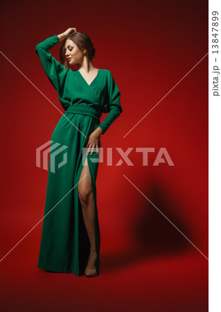 Female fashion model posing in green dress Female fashion model posing in green dress 13847899