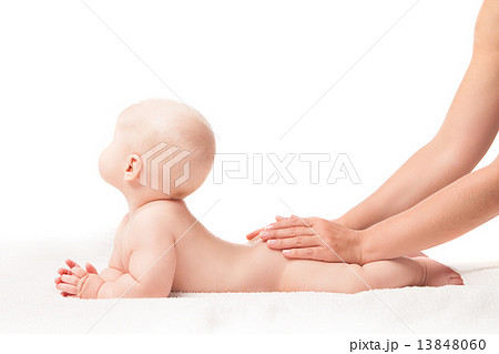 Cute baby lying. hands massaging his bottom 13848060