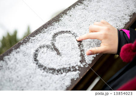 little girl drawing heart on snow little girl drawing heart on snow 13854023