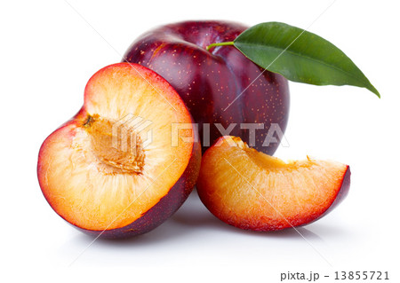 Ripe purple plum fruits with green leaves isolated on white Ripe purple plum fruits with green leaves isolated on white 13855721