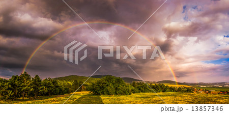 Rainbow over Landscape at Sunset Rainbow over Landscape at Sunset 13857346