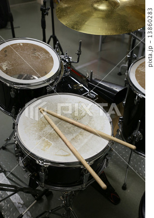 Drum set in training room with vintage style pictures. Music equipment in training room. 13860283