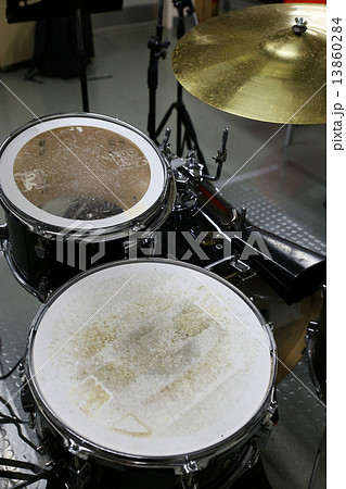 Drum set in training room with vintage style pictures. Music equipment in training room. Drum set in training room with vintage style pictures. Music equipment in training room. 13860284