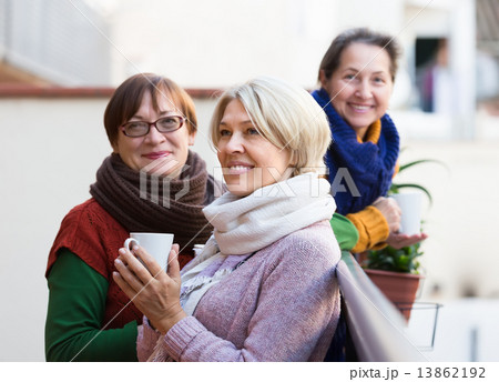 Senior women drinking tea at balcony 13862192