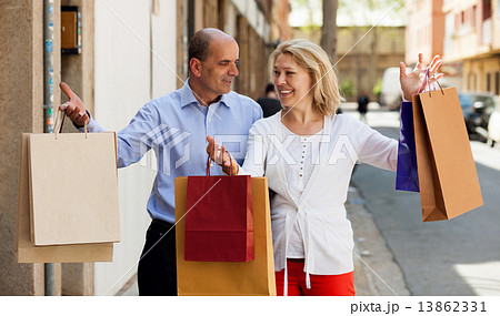Senior with mature woman having shopping tour in city Senior with mature woman having shopping tour in city 13862331