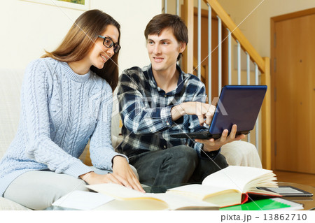 students with laptop preparing for examinations 13862710