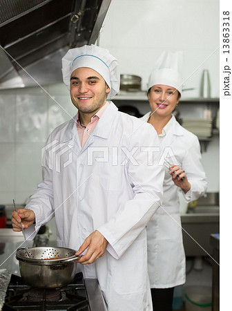 Head-cooks cooking at professional kitchen 13863318