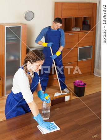 Professional cleaners cleaning in room 13863382