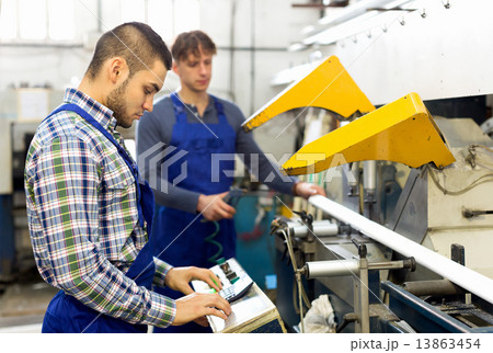 Workers cutting window profiles Workers cutting window profiles 13863454