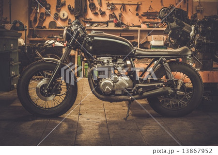 Vintage style cafe-racer motorcycle in customs garage 13867952